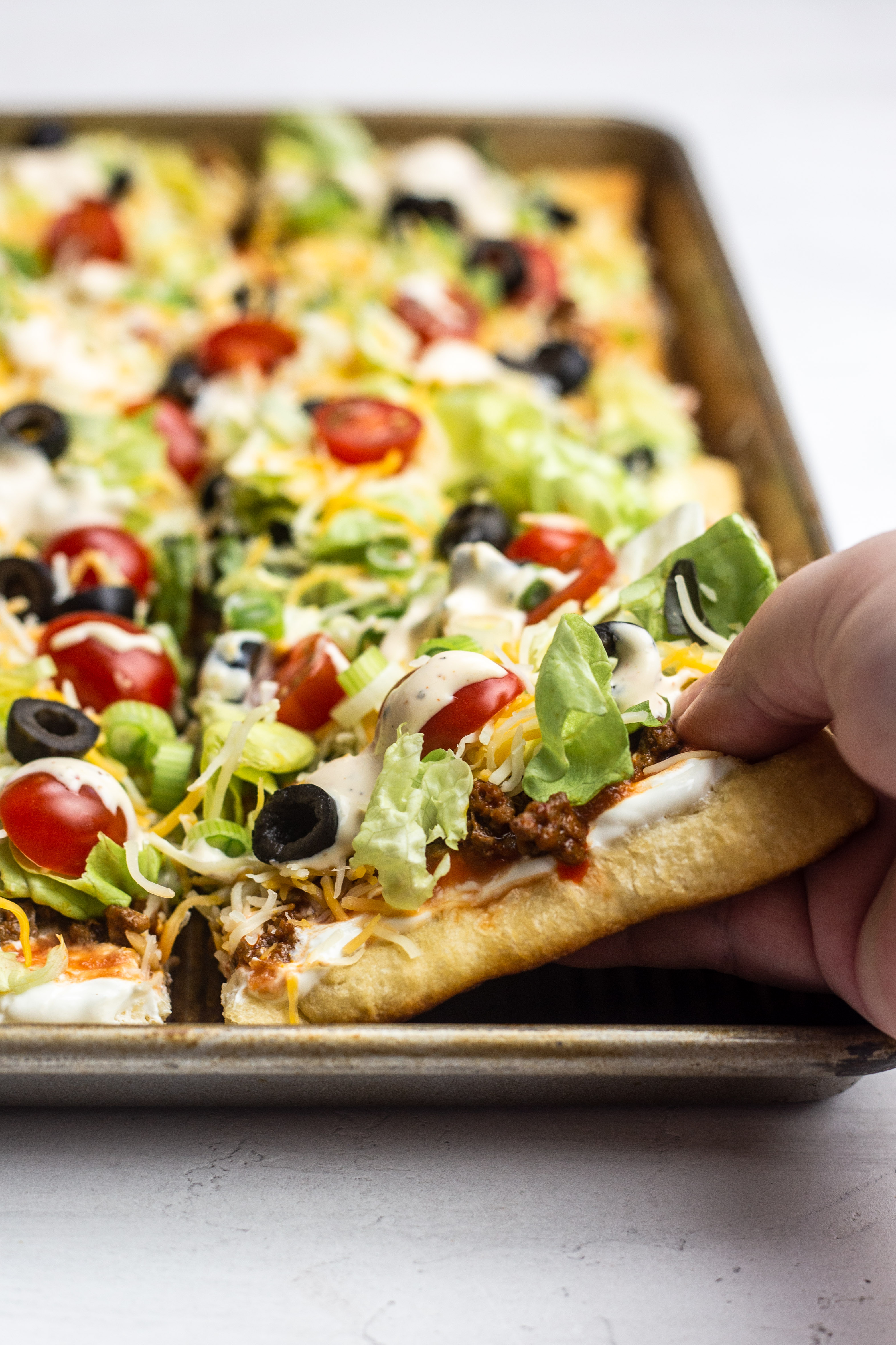 Taco Pizza combines two favorites for the perfect easy meal! This recipe is made using crescent roll dough for a tasty meal everyone will love!