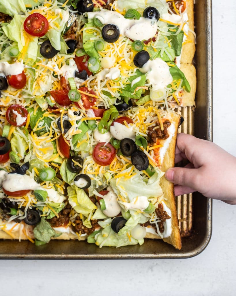 Taco Pizza combines two favorites for the perfect easy meal! This recipe is made using crescent roll dough for a tasty meal everyone will love!