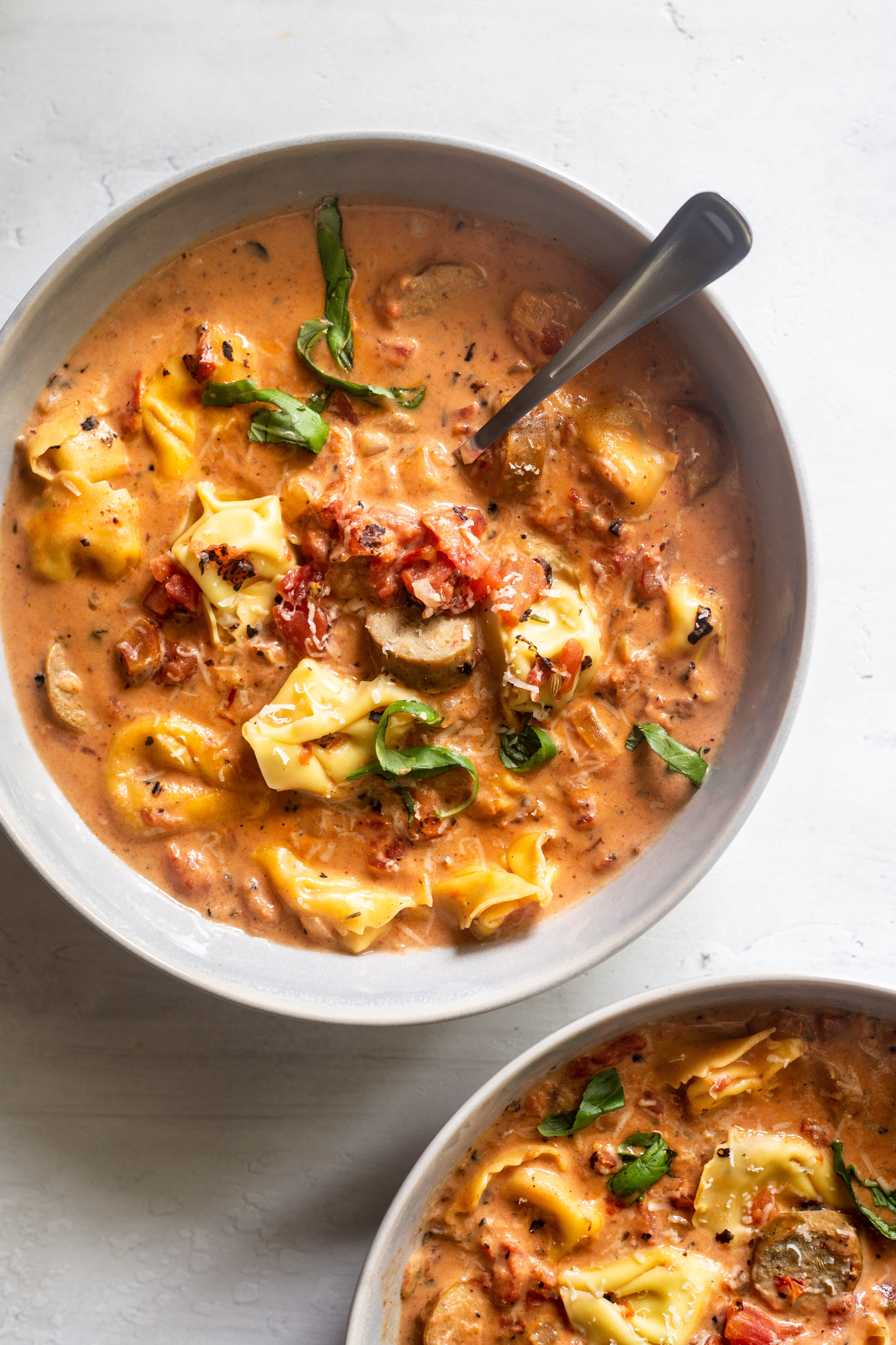 This Sausage Tortellini Soup comes together quickly with a rich and creamy tomato base, Italian chicken sausage and cheese tortellini.